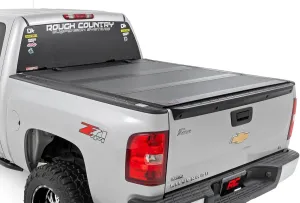 Rough Country Hard Tri-Fold Flip Up Truck Bed Tonneau Cover for Chevy Silverado and GMC Sierra 1500 (2007-2013) - Fits 5'9 (69.3") Bed with Rail Caps